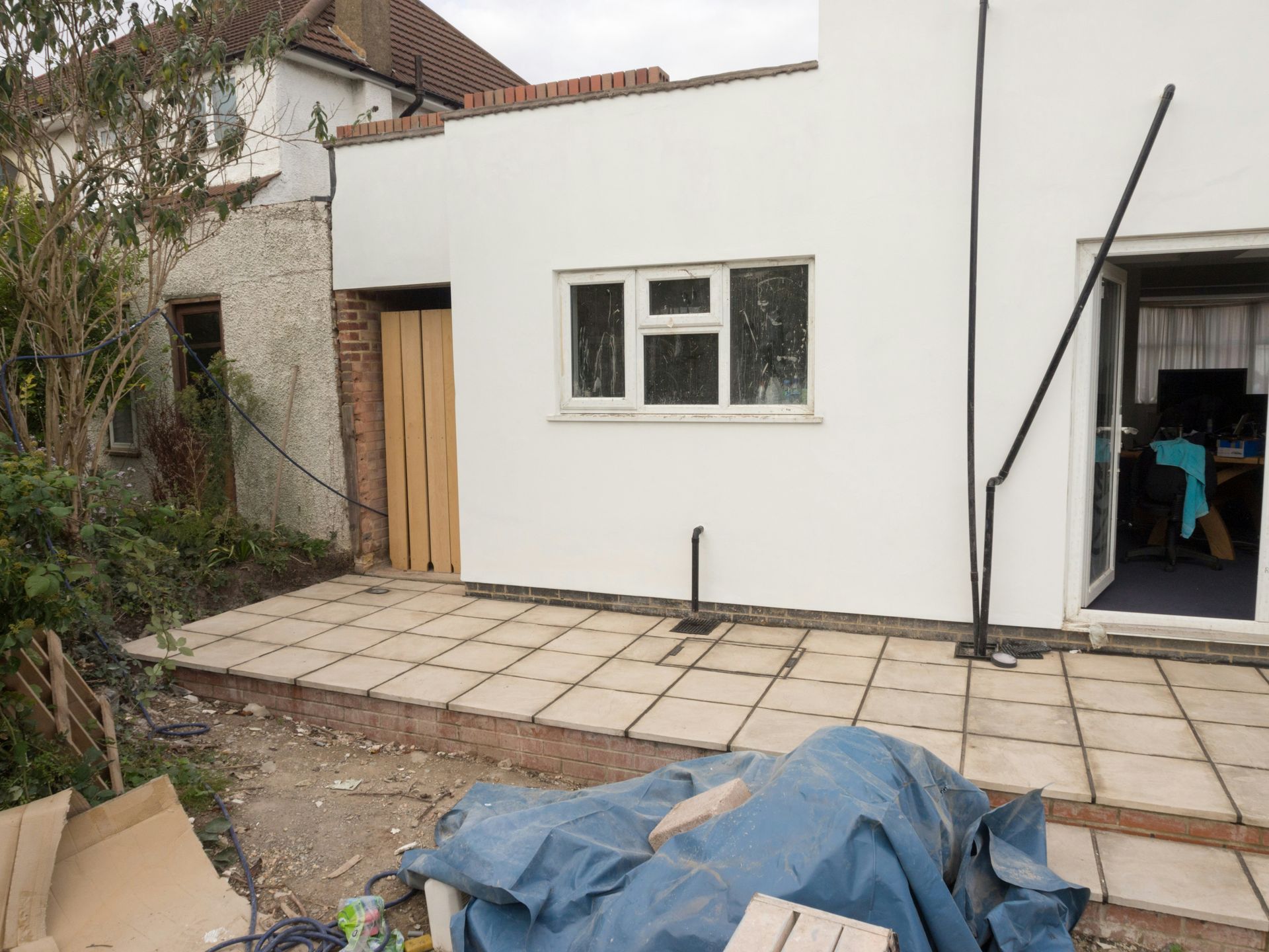 House exterior with white walls and a patio.